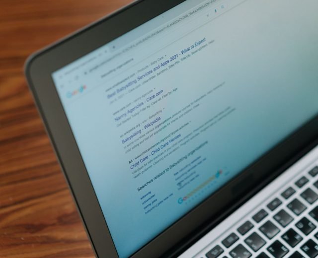 A close-up view of a laptop displaying a search engine page.
